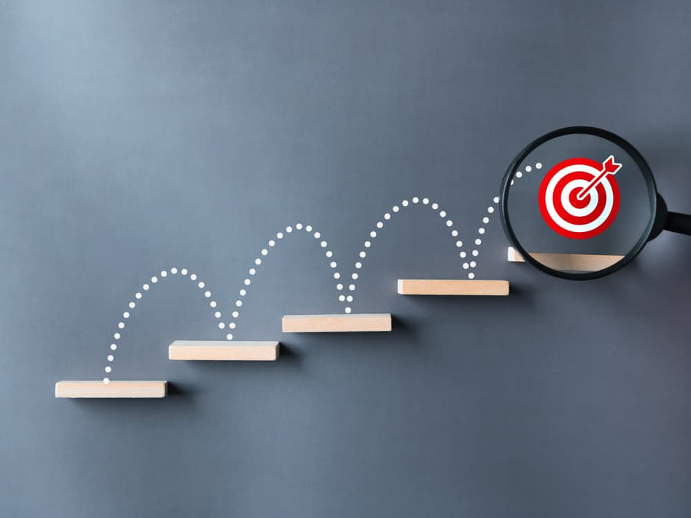 Steps leading to a target, representing operational growth